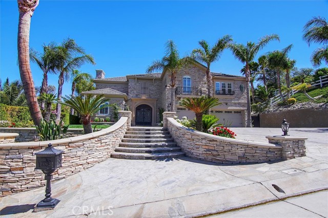 Canyon Country, California Beautiful Sand Canyon Estate! This Mediterranean style estate is a must see! Fully remodeled inside and out, this turn-key home shows tremendous pride of ownership! Custom stone work and hardscape and the expanded drive way and 3 car pull-thru garage leave plenty of room for RV parking. The gated front door opens up to an impressive staircase and crystal chandelier in the foyer. The living room leads to the adjacent formal dining room and piano room/library. The spiral staircase opens up to a Romeo and Juliette balcony. The large primary bedroom has custom stone and wainscoting and a large newly remodeled bathroom complete with jacuzzi tub and chandelier and his and hers closets. The rec/movie room is large enough to accommodate friends and family for a game of pool or movie a night. Large family room and chefs kitchen are perfect for entertaining! Large double islands, bold crown and wainscoting and hand painted Italian tile backsplash along with the Viking appliances and custom cabinetry make this a chef's dream! Wait! if you like to entertain then you have to come see this backyard! Large covered patio covers the outdoor living space which includes a built in barbeque, TV, fireplace and ceiling fans. The resort style pool has just been refinished with new plaster and tile and boasts 2 jacuzzi's, a grotto and a slide. Surrounding the pool is an enchanting yard with palm trees and grassy areas perfect for big parties. Plenty of storage, this home comes with a two story, fully finished unattached garage with an outdoor bathroom, great for pool parties! Brand new full house generator runs the entire home and pool equipment if needed. Too many amenities to mention!