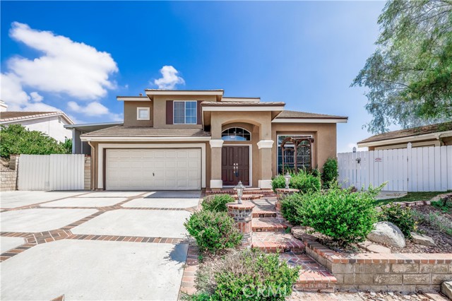 Front of home with large driveway.