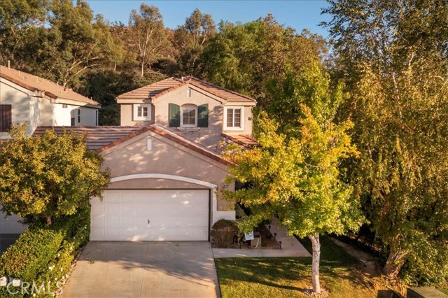 23614 Silverhawk Place Valencia, California Valencia living at it's best. Why settle for a condo or townhome when you can have a beautiful single family home in a fantastic community with amenities galore? Don't let the 2 bedrooms fool you; there is a downstairs den/office that can easily be converted to a 3rd bedroom if needed. You'll enjoy the elegant, updated kitchen with gleaming quartz counters and beautiful cabinets; including select glass fronts to highlight your special pieces, and a pantry with slide out shelves. Sip your morning coffee at your dining table while looking out your sliding glass doors at your lush, spacious backyard. No neighbors behind you affords privacy and plenty of room for visiting birds and squirrels. Laminate flooring throughout the home make clean-up a breeze. Upstairs you'll find two roomy bedrooms and a spacious loft. This home has been well cared for, with many upgrades made within the last 6 years. No need to leave for the weekends. Your Northpark community has 3 pools, tennis courts, basketball courts, a beautiful park and more, for all of your recreational needs. Super low HOA and no Mello Roos make this a very affordable community. As if all of the home and community charms aren't enough, add in award winning schools and this home truly can't be beat. Hurry in to see it this weekend.