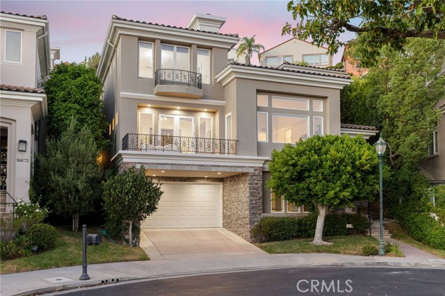 16671 Calle Brittany Pacific Palisades, California A transcendent view home showcasing prolific mountainside and ocean sights in the Pacific Palisades Highlands. Securely nestled behind the Peninsula gated community at the end of a quiet cul-de-sac lies this charming, contemporary 4,583-square-foot, residence. The four-bedroom, four-and-a-half-bath, plus bonus room, would make a great movie theater, den, or game room. Throughout the home are high ceilings, cozy hardwood floors and a seamless open floorplan. On the first floor is an ensuite bedroom, entertainment room, and oversized laundry room. The home continues to impress on the second floor with an elegant family room, living room with a large picture window and fireplace plus two dining rooms that flow into the bright and spacious windowed kitchen. The center-island kitchen features plenty of storage space, a wine fridge, quartz countertops and backsplash as well as a Monogram stovetop, ovens and dishwasher. A balcony and lushly landscaped palm-tree backyard with a complete outdoor kitchen make al fresco meals an easy option, any time of year. Find a large primary bedroom on the third floor, presenting a beautiful fireplace and ensuite bathroom with a grand, spa-like soaking tub, ocean views, dual sinks and large glass shower. Enjoy two more ensuite bedrooms, plus an open office. An elevator, oversized four-car garage and ample street parking make this compound easily accessible. Enjoy access to private multi-acre Summit club which grants entry into pool, spa, gym, tennis court, and plentiful other recreational facilities. Just minutes from serene hiking trails, majestic beaches and the Caruso Village shopping center.