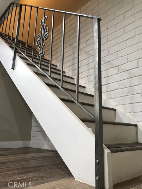 Restored stair rail with contemporary brushed steel finish
