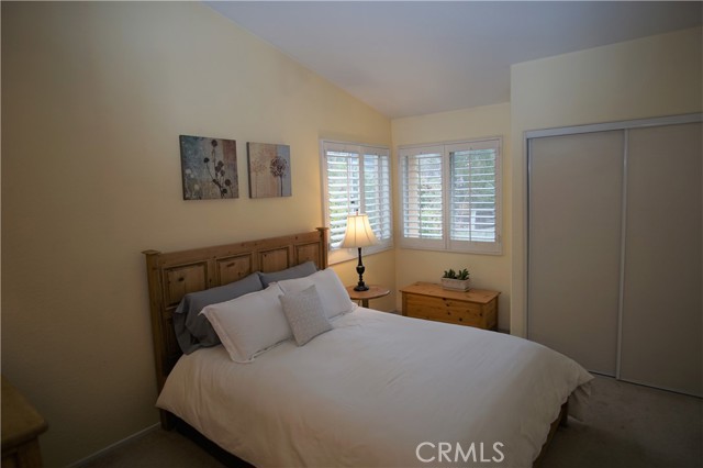 Upper Level First Bedroom with Attached Bathroom and Greenbelt View