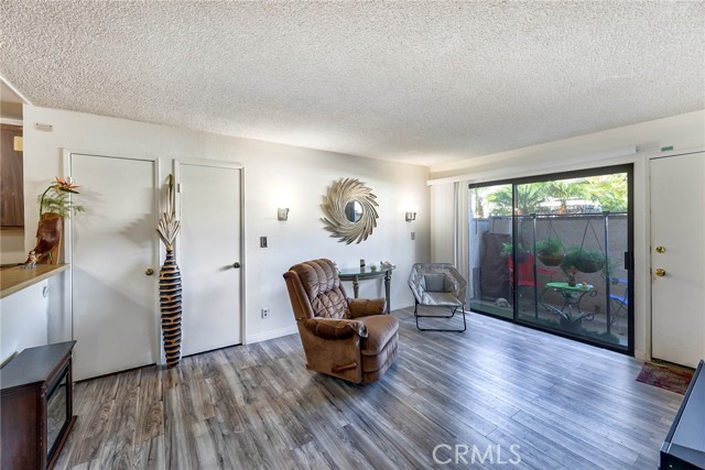 Family room with laminate flooring and 2 storage closets.