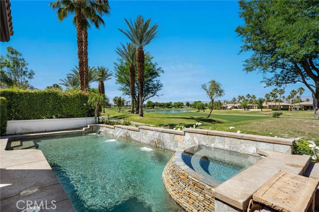 80526 Spanish Bay La Quinta, California Don't miss this incredible Spanish Bay home (Popular Quevado Plan) on the 18th fairway with Lake & Mountain Views. Steps from the Tournament Clubhouse. Enter the private courtyard, which features a custom waterfall and Pergola to enjoy the view of the Santa Rosa Mountains. Once you enter this 3 bedrms,3.50 baths designer home that has been furnished with Restoration Hardware furnishings and lighting throughout the home. The formal living room features high ceilings and French doors leading to the courtyard. The cooks kitchen has granite counters and a oversize island with Viking appliances, there are also travertine floors throughout the home and recessed lighting. The family room features a stone fireplace with bi-folding doors opening to the covered patio which is perfect for entertaining indoor/ outdoor. The expansive master bedroom features a double sided fireplace and leads to the luxurious master bathroom with an oversize tub and his and hers vanity sinks. The entertainers yard features a saltwater, pebble tec pool/spa with cascading waterfall with views of both the lake and golf course.