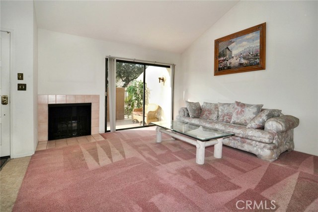 Living room with  gas fireplace and access to private patio.