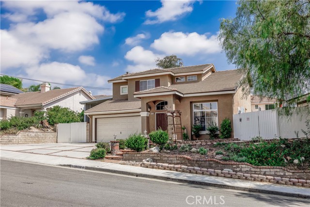 Front of home with large side yards.