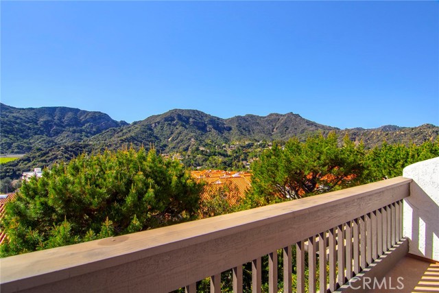 1694 Michael Lane Pacific Palisades, California Presenting an incredible nearly 2,500 sq. ft. townhome ideally positioned to provide 180-degree spellbinding views. Welcome to Michael Lane Villas, tucked away amongst all the serene natural beauty of the Palisades Highlands. The short drive up Palisades Drive provides ample opportunity to decompress & leave all your troubles behind. Enter through a large gated patio. Inside, each & every west facing window frame glorious visions of the surrounding lush green mountains & your primary suite's private balcony provides a sumptuous sight of the hypnotic blue pacific. This unique floorplan features a spacious living room with wet-bar on the entry level. This space would also make an amazing theater, game room or with the upgraded bathroom, a massive ensuite can be created...possibly even a rental. At the mid-level, which offers direct two-car garage access, enjoy a beautifully remodeled kitchen with quality new appliances, custom cabinetry & loads of stunning counters. An adjacent dining room with large window ensures the dazzling sights are right by your side with each & every meal. Spacious & bright Family room affords a fireplace, balcony & gorgeous powder bath. On the upper-level, the primary suite features soaring ceilings, romantic fireplace, large walk-in closet, private bath & balcony as an ideal platform to stake claim to all the incredible views that surround. Fresh new interior paint, New HVAC & ducts, new interior doors & hardware, new bathroom vanities & upgraded LED lighting further enhance this wonder place to call home. The meticulously maintained complex affords a beautiful pool, soothing spa & recently remodeled gym with sauna. Mere moments to ideal hiking, PCH & the beach in one direction & vibrant Palisades Village in the other. Don't miss your chance to secure this prime locale within this highly sought-after development. For those with children, benefit from only the finest schools. Don't miss!