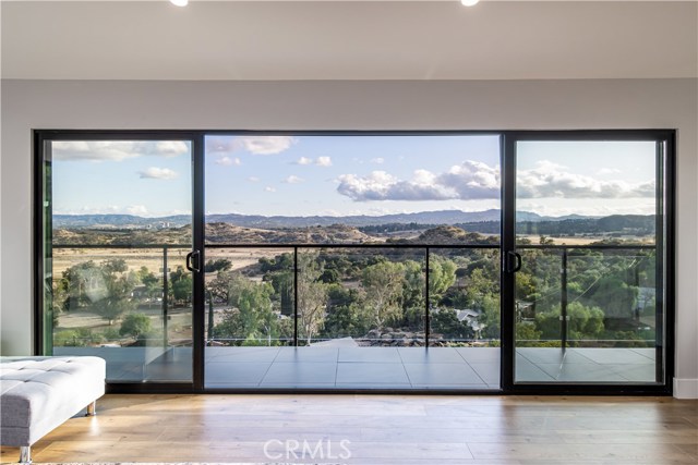 23532 Ehlers Drive Chatsworth, California Welcome to this hillside home located in the Lake Manor neighborhood of Chatsworth. Every window offers stunning mountain and valley views in this completely remodeled 3 bed, 3 bath home. Everything in the house is new A-Z, including new roofing, new smooth stucco, and all new windows. The double door entry opens to the completely open floorplan with stone fireplace in the entry, vaulted ceilings, built-in sound system, and recessed lighting throughout. The modern kitchen features a large center island, stainless steel appliance, and white shaker cabinets. The spacious living room boasts large picture window and large, 4-panel sliding glass doors that provide excellent views and lead to the glass-surround, wrap-around deck. The home features 3 bedrooms, including a master with sliding glass doors to an outdoor deck and en-suite bathroom featuring a floating vanity and glass surround shower with ultra-modern fixtures. There are two more baths and a detached, oversized 2-car garage that can easily be converted to an ADU. A MUST SEE!!! Property consists of 6 parcels - all of which total 12,079 sf lot size. APN's included: 2006-013-029, 2006-013-028, 2006-013-027, 2006-013-026, 2006-015-012, 2006-015-011. Adjoining land to east of property can be purchased for an additional $89,000.