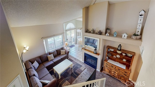 Living room view from upstairs loft includes fireplace