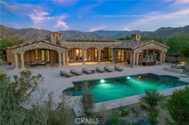 74360 Desert Arroyo Trail Indian Wells, California If you ever wanted to live in Italy, here's your chance. This beautiful custom home in THE RESERVE is like no other. Completed in 2011, this approx. 5,450 sq.ft home with approx. 34,000+ sq.ft. lot could be yours. Also, enjoy the one bedroom guest house w/own washer and dryer, tankless water heater-also in main house. You'll be delighted to see the custom cabinets by Francis and Wane and the kitchen featuring Northland stainless interior refrigerator and freezer with kitchen range by CornuFe by LaCornue. Also, there's a GE Advantium multi purpose oven in kitchen island. Butler's pantry w/slat wall storage, sink, dishwasher, drawer refrigerator & microwave. Calcutta Oro marble on kitchen island and in both master baths. Her master bath is designed by Barbara Barry and Kallista. His and Hers separate bathrooms with walk in closets. Three zone high efficient a/c in main house, smart home technology, 6 fireplaces and Venetian Murano light fixtures. Large central courtyard with two antique fountains. Enjoy the covered outdoor entertainment area of approx.3,000 sq. ft., the pebble tec pool, spa, gas firepit, solar, and outdoor kitchen w/Lynx BBQ and refrigerator. Full wired alarm system plus security cameras. 3 full garages and one golf cart garage. Surrounded by glorious mountains.