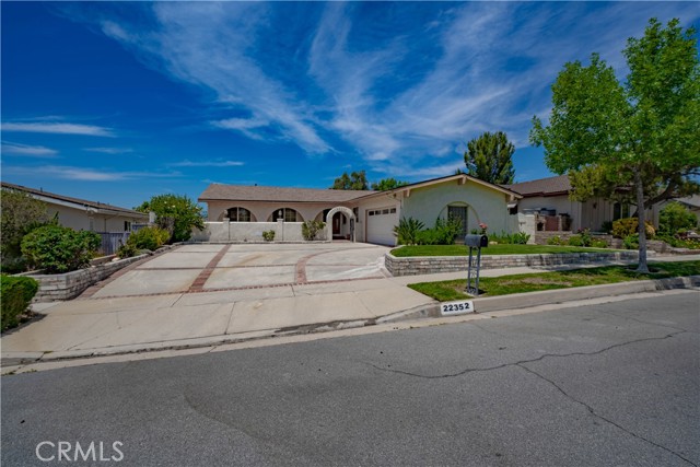 22352 Barbacoa Drive Saugus, California Come and experience one of the most spectacular views in the Santa Clarita Valley! This elegant home offers an amazing open floor plan that showcases the beautiful ranch style, single story home. The bedrooms have vintage hardwood floors and the large kitchen opens into the dining and family room. The high custom wood ceilings brings in the light and makes this home perfect for entertaining. The huge driveway is large enough for your recreational toys! There is no need to pay storage fees. Park your RV, Boat or Wave Runners right outside.