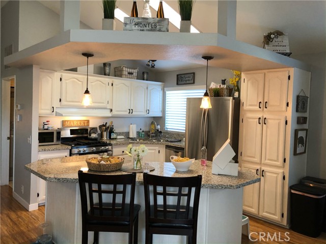 Kitchen open to living room with fireplace