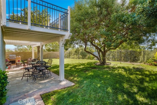 Lush yard with covered patio and view