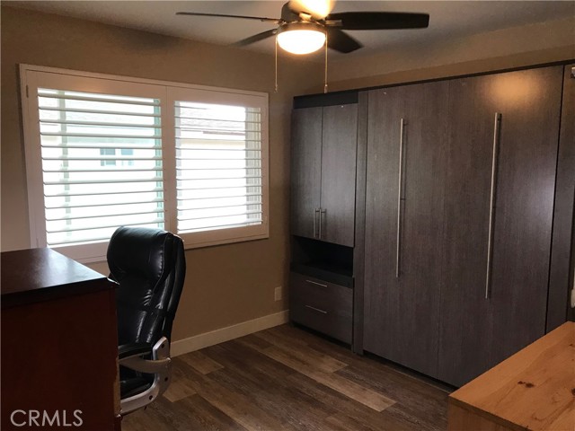 Secondary bedroom with real wood plantation shutters and Murphy bed