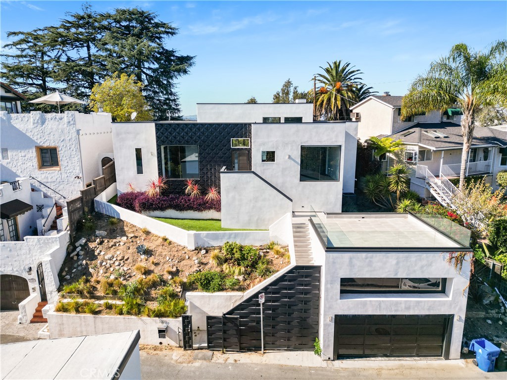 Fabulous modern style home nestled in the Hollywood Hills area known as "Hollywood Manor" surrounded by picturesque views. This open concept house has lots to offer with high vaulted ceilings, full wall height glass pocket doors for an indoor/outdoor feel, large open deck in the front with glass border fence to observe the beautiful views and so much more. The kitchen offers a large center marble island and built in LED lighting around the cabinetry. Each bedroom is its own suite with private bathrooms. In addition, there is an indoor laundry room with side-to-side hook-ups. Additional features include the peaceful backyard space with artificial turf, infinity edge pool and spa and more mountain views. This is an entertainer's dream! Conveniently located only minutes from Universal Studios, Warner Brothers Studios, The Hollywood Bowl, Walt Disney Studios, hiking trails, fine dining and entertainment, freeways and so much more.