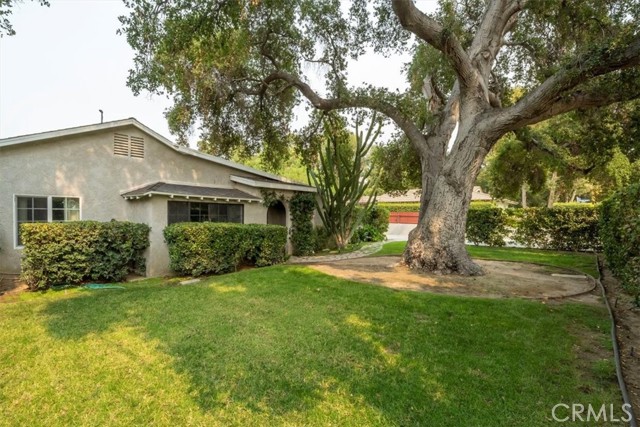 23263 8th Street Newhall, California You'll fall in love with this home from the minute you arrive. Set back from the road with a private front yard featuring a majestic oak tree, you'll enter into a large living room with beamed ceilings, arched door ways, tile flooring, 2 sets of french doors letting in lots of natural light, and views of the courtyard. The courtyard is the perfect spot for entertaining or just relaxing with family and friends. The kitchen has been updated with white cabinets, marble counters, large basin sink and has a large window with great views of the front yard. The owner's suite features vaulted beamed ceilings, a cozy fireplace, french doors with views of the backyard. The en-suite bathroom that has been updated with marble, a separate soaking tub and shower. There are 2 more bedrooms both with ceiling fans and another full bathroom with double sinks, marble counters and white cabinets. Outside, the backyard is spacious with a large grassy area, huge storage shed and easy access to the detached 2 car garage. This home has a long driveway that can easily fit an RV or any other toys you may have. Located in a private, secluded neighborhood but close to shopping, restaurants, parks and schools, this home can be your own private getaway!