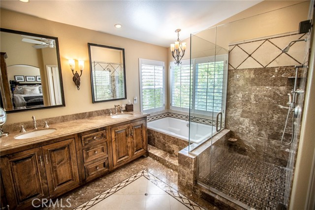 Remodeled master bathroom featuring his and hers sinks as well as a beautiful walk in shower and soaking tub.