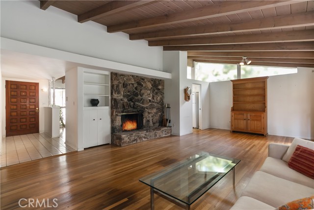 Living room with hardwood floors & an open beam ceiling