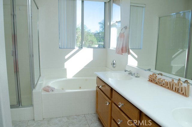 Primary bathroom with spa tub and separate shower enclosure