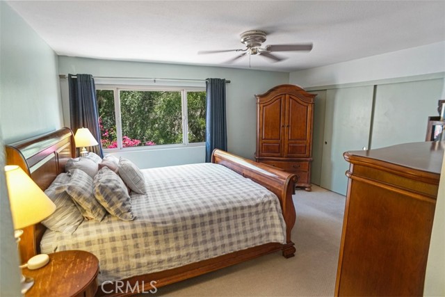 Primary bedroom with view of trees