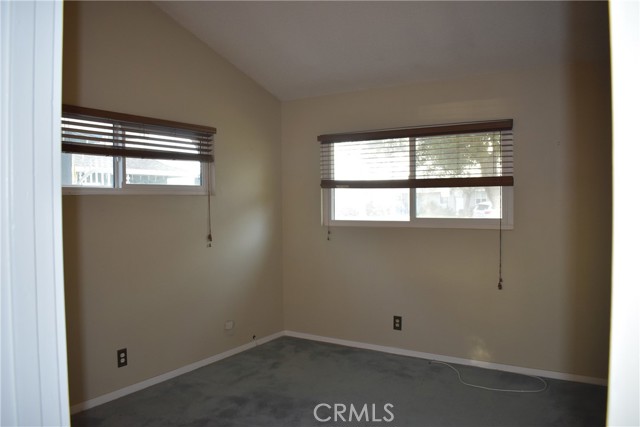 Primary  bedroom overlooks front yard.