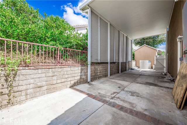 Side yard with covered RV parking.