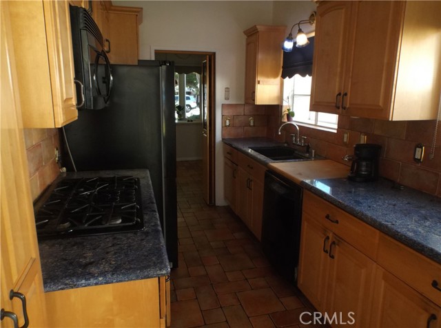 View of galley kitchen looking from rear door toward dining area.