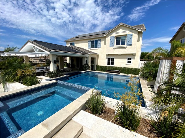 Pool with raised spa, swim up bar, rain curtain, two waterfalls, baja shelf with two bubblers, solar heating and normal heating