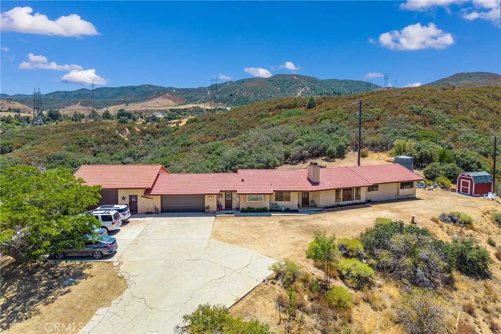 14320 Kiptree Drive Lake Elizabeth, California Need Space, Need a Workshop? Well this is it! With more than 5 acres, 1130sf workshop & 2123sf house what more could you ask for? Oh, and a VIEW! Workshop is well insulated & wired for 220v, Gladiator Gear Wall, some shelving stays, outdoor shed houses the air compressor to keep the noise down. All new LED lighting. House has large bedrooms, 3 baths (1 full, 2-3/4) all with tile floors & tub/shower surrounds, double sink in the main bathroom. Main bedroom has a walk in closet w/barn door. The spacious living room has vaulted ceilings, woodburning rock fireplace, picture window & slider to the backyard. The kitchen has new countertops, new huge garden window & appliances. The laundry/mud room has built-in cabinets & a dog washing station! Access to the 2 car garage w/auto opener & insulated sectional door. The backyard has been snake proofed for pets, kids & adults, river rock creek bed, fully enclosed dog run w/access indoors. Lots of trees & native vegetation. This is Paradise!
