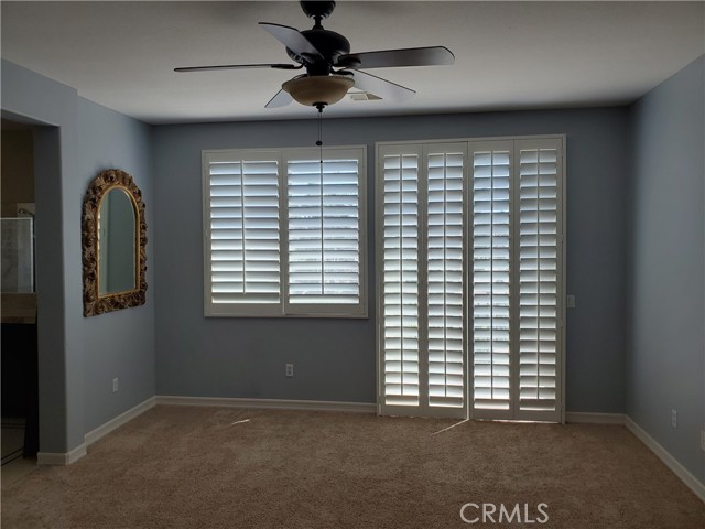 Master bedroom with  ceiling fan and slider to balcony