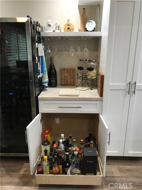 Pull-out liquor cabinet beneath dry bar