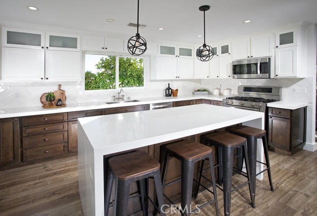 Kitchen
• Newer expanded/enlarged Kitchen
• Newer kitchen island with Kenmore® 45 bottle wine chiller
• New industrial Atom 8-foot-wide LED Edison bulb mini-pendant lights
• Newer 4-inch energy star 5000K LED recessed lights
• Newer shaker style cabinets w/frosted glass door and crown mouldings
• Newer self-closing cabinets doors and drawers
• Two newer lazy Susan’s cabinets
• Newer LED over the counter lighting
• Newer Decora® outlets and switches
• Newer Decora® USB outlets
• Newer sugar white