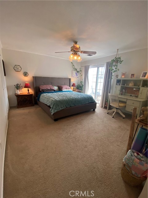 Very Large Master Bedroom with large front facing deck, two large closets (one of which is a walk in closet), ceiling fan and crown moulding