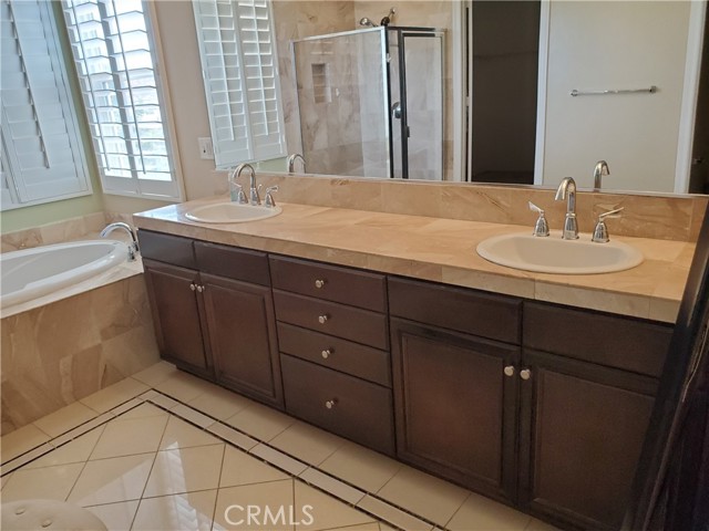 Master bath with dual sinks, sunken tub ...wonderful tile floors and walk in shower