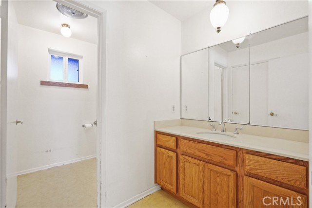 Downstairs bathroom with shower opens to main living area and is attached to downstairs primary bedroom