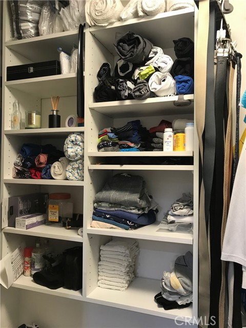 Primary bedroom walk-in closet storage