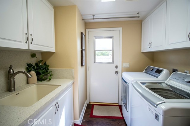 Downstairs laundry room featuring nice size sink.