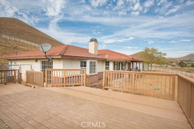 2521 Soledad Canyon Road Acton, California ONE OF A KIND DREAM HOME WITH CITY VIEWS...! 40K Reduced price. This fabulous remodeled 3 bedrooms and 2.25 bathrooms and 5.1 ACRES, shows a beautiful new water proof laminated wood flooring throughout the house and new Spanish tile in the family room. New fresh paint interior and exterior. There 2
fireplaces, one in the living room and another one in the family room. Enjoy the magnificent views from the living room, family room and 2 of the
bedrooms. The family room has a door that leads to ta large trek deck. Remodeled spacious kitchen has brand new electric stove, new granite
counter tops, recess lighting, and view to the mountains. The master bedroom has recess lighting and a ceiling fan. The new remodeled master
bathroom has new elegance natural marbles tiles in the shower and the counter top. There are 3 studs shed row barn with hay storage, tack room
and super-size pasture for your horses. About 3 acres are fenced with white rail vinyl fencing. THIS HOME IS A GEM. !!! THIS HOME WON'T LAST. !!!