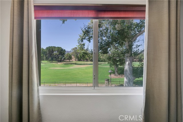 master bedroom with lake and golf course views