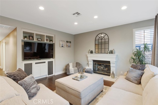 Media room w/custom built in shelves, cabinets, and fireplace