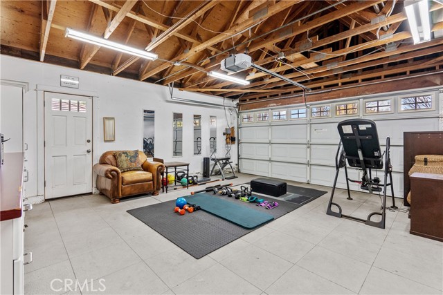 Garage flooring built in cabinets and drywall has excellent lighting