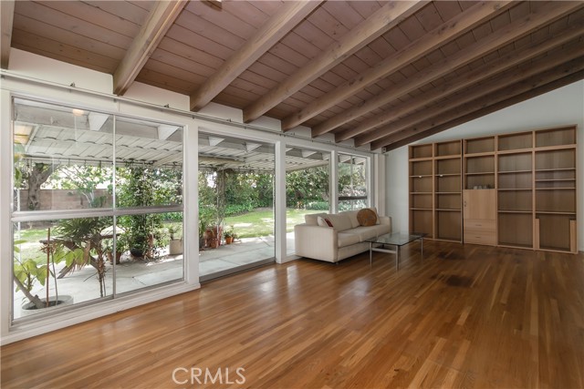 Living room with view of the yard. Shelving unit is included.