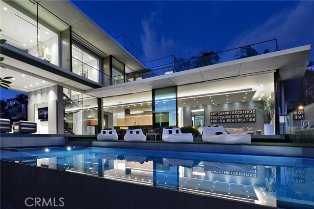 1807 Blue Heights Drive Los Angeles, California Perched high in Hollywood Hills West above the Sunset Strip, this striking 5540-sq-ft modern
masterpiece is an ode to glass, space, and sightlines. Envisioned by renowned bicoastal
architectural firm Fu Wilmers Design, 11-ft floor-to-ceiling vanishing doors, windows and glass-
walled decks blur the barriers between inside and out, showcasing jetliner views that span from
city to ocean to mountains across an infinity-edge pool. Each angle displays superior materials,
from the full Miele kitchen to German Badeloft fixtures, within a flowing open layout and chic
neutral palette. There are 5 spacious bedrooms, 7 baths, and a skylit lower-level flexible
entertaining space with a bar, gym, wine room and a Dolby Atmos theater; it’s an integrated
smart home as well. Built just in 2018, this extraordinary property is now fully realized in every
aspect, from its impeccable landscaping to its newly finished wooden rooftop decks. Rise above
it all and live above it all in this unforgettable oasis.