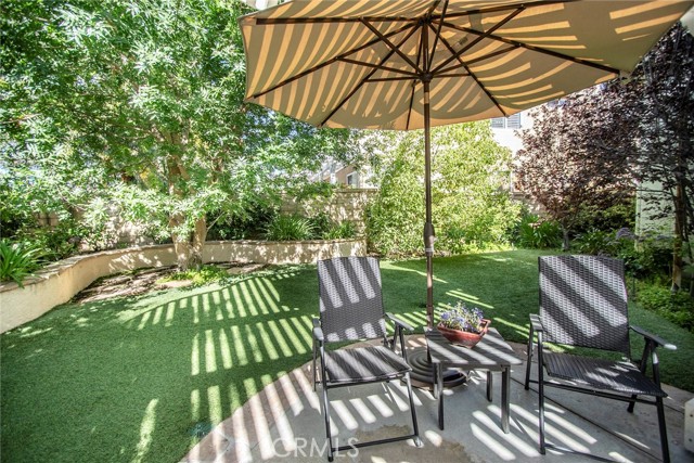 Lots of grass and greenery in this shady outdoor space.