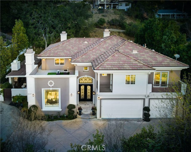Reimagined & Beautifully Renovated! This beauty is located in stunning Park Moderne, a gated community nestled in the hills of prestigious Calabasas.  Drive up to double automatic gates into a lushly landscaped community of 4 custom built homes. Situated privately in the back, find a long driveway with ample parking. Inside, find a grand entrance featuring soaring ceilings, custom lighting, a combination of travertine & new wide plank wood flooring, fresh paint, LED lighting, custom built porcelain & stone fireplaces, a gourmet chef's kitchen boasting new quartz counter tops, Thermador appliances & sleek white cabinetry all overlooking the oversized family room & wet bar. The formal living room flows into the dining room & opens directly to the outdoor cabana, fireplace & outdoor bar perfecting the California indoor/outdoor living space. Downstairs, also find a junior master suite (currently designed as a home office), separate laundry room with quartz counter tops & a 3 car garage. Follow the iron staircase upstairs to find 4 additional bedrooms, each with their own updated en-suite baths. Hardwood floors lead the pickiest of guests from room to room. The massive owner's suite boasts 2 large walk-in closets, a fabulous sitting area with a sleek stone fireplace, a fantastic en-suite fit for a queen, & a balcony leading to the roof top deck boasting views of gorgeous Calabasas. The entertainers yard in surrounded by mature trees and comes complete with a sparkling, pebble tech swimming pool, spa, grotto waterfall, multiple relaxation areas, outdoor cabana, outdoor kitchen, & a serving bar, perfect for entertaining. Just minutes away from award winning schools, the Calabasas Lake, boutiques, cafes & more....