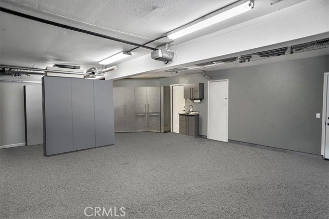 3-Car Garage with cabinets and workbench