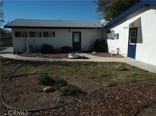 Back yard area behind bonus room and in front of pool.