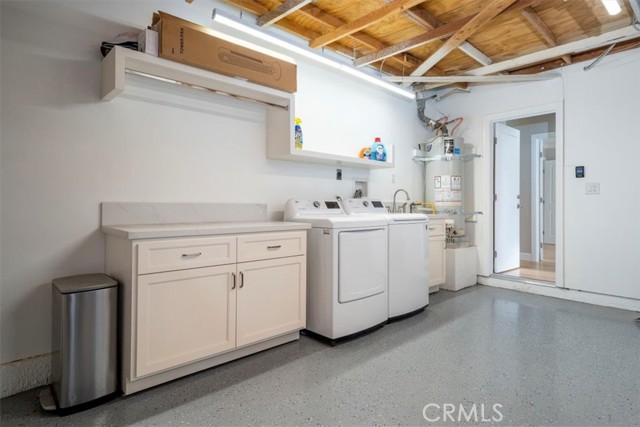 Laundry in Garage with direct house access, Updated with newer lighting, hanging clothes Bar, cabinet with Quartz countertop, plus,  a garage Sink. Also a Drywalled Garage & Sharply upgraded floor sealed & epoxy coated. Water heater has been replaced.