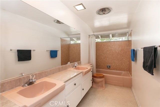 Hallway full bath with double sinks