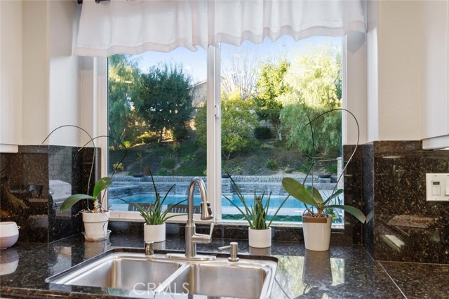 kitchen sink backyard pool view